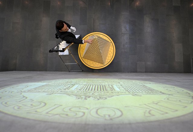 Benjamin Summa, press spokesman from “pro aurum” puts down a mint, in collaboration with the Austrian mint the precious metal dealer “pro aurum” presents almost a three meter gold tree consisting of 2,024 Vienna Philharmonic coins, which has a value of more than 5 million Euros and is not for sale, in Munich, Germany, on December 3, 2024. (Photo by Angelika Warmuth/Reuters)