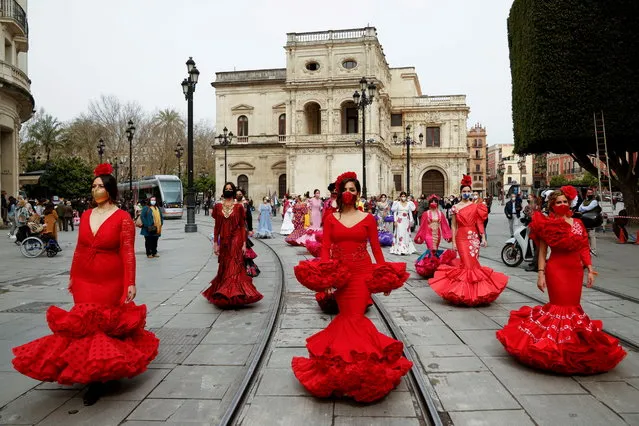 Women wearing flamenco dresses take part in a protest against the crisis in the flamenco fashion sector generated by the coronavirus disease (COVID-19) pandemic, in Seville, Spain on February 26, 2021. (Photo by Marcelo del Pozo/Reuters)