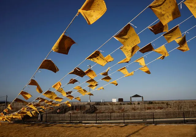 Yellow handkerchiefs bearing messages supporting people in areas hit by the 2011 earthquake and tsunami are hanged at Iwaki 3.11 Memorial and Revitalisation museum ahead of the ten years anniversary of the disaster in Iwaki, Japan, March 10, 2021. (Photo by Kim Kyung-Hoon/Reuters)