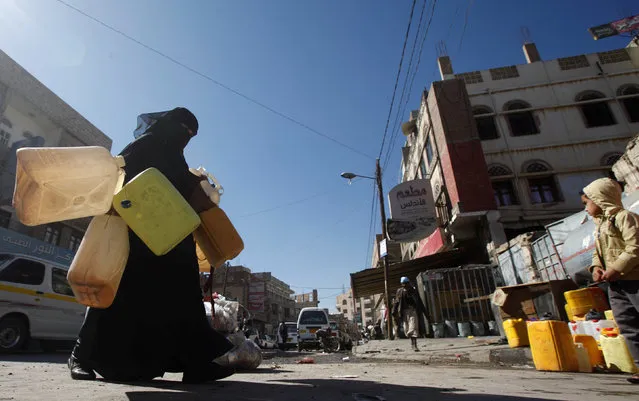 A woman carries empty jerrycans to fill them with potable water from a charity tap during the first day of a 48-hour ceasefire in Sanaa, Yemen November 19, 2016. (Photo by Mohamed al-Sayaghi/Reuters)
