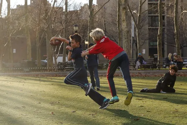 Young boys play in a park during an unusually warm winter day in the Brooklyn borough of New York December 15, 2015. (Photo by Lucas Jackson/Reuters)