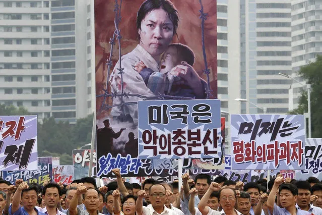 In this June 25, 2017, file photo, tens of thousands of men and women pump their fists in the air and chant as they carry placards with anti-American propaganda slogans at Pyongyang's central Kim Il Sung Square, in North Korea, to mark what North Korea calls “the day of struggle against U.S. imperialism” – the anniversary of the start of the Korean War. In another sign of detente following the summit between North Korean leader Kim Jong Un and U.S. President Donald Trump, North Korea has opted not to hold this year’s “anti-U.S. imperialism” rally. (Photo by Jon Chol Jin/AP Photo)