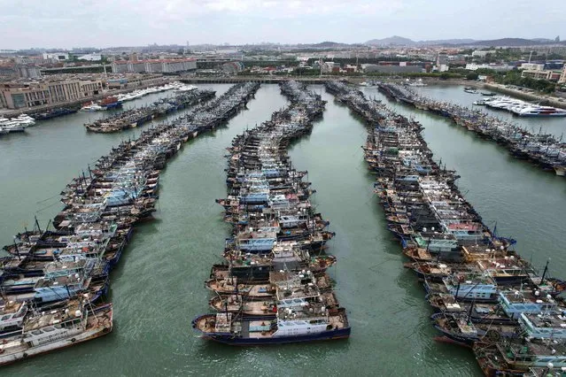 Fishing boats are moored at a port in the Gaoqi locality of Xiamen city at Fujian province in preparation for the approaching Typhoon Doksuri on July 26, 2023. China on July 26, 2023, issued its highest alert for Typhoon Doksuri, stopping trains and calling fishing boats to shore as the storm approaches. (Photo by AFP Photo/China Stringer Network)