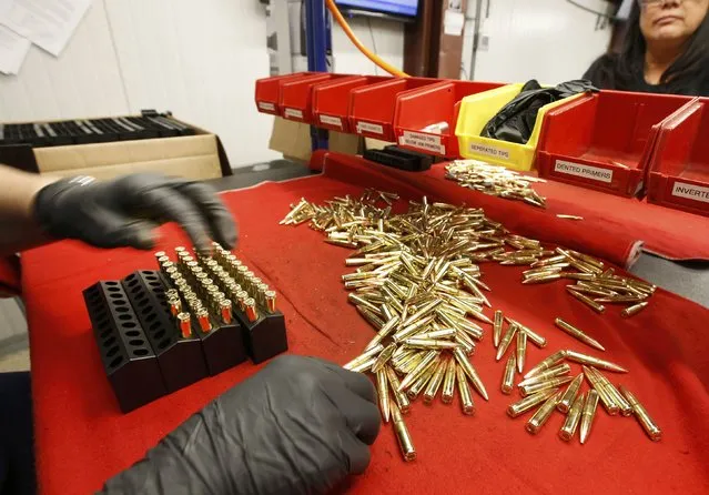 A worker puts finished 300 AAC Blackout rounds into packaging at Barnes Bullets in Mona, Utah, January 6, 2015. (Photo by George Frey/Reuters)