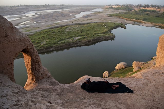 A Afghan man takes rest at abandoned structure at the Qal-e-Kohna overlooking Lashkar Gah river in Helmand province on March 27, 2021. (Photo by Wakil Kohsar/AFP Photo