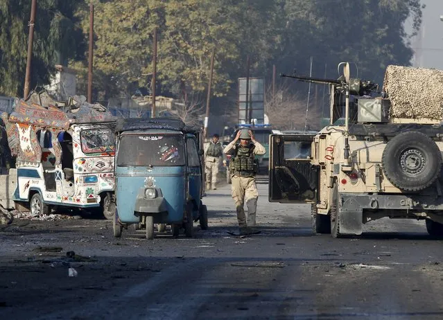 A member of the Afghan security personnel adjusts his helmet after a blast near the Pakistani consulate in Jalalabad, Afghanistan January 13, 2016. (Photo by Reuters/Parwiz)