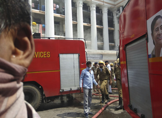 Firefighters work to control a fire at Calcutta Medical College and Hospital in Kolkata, India, Wednesday, October 3, 2018. A fire broke out in a pharmacy at a state-run medical college and hospital complex in eastern India, causing panic among nearly 250 patients who have been evacuated to safe wards. No casualties have been reported. (Photo by Bikas Das/AP Photo)