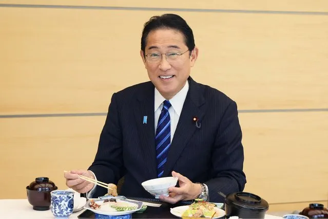 This handout photo taken and received from the Cabinet Public Relations Office via Jiji Press on August 30, 2023 shows Japan's Prime Minister Fumio Kishida posing as he eats seafood from Fukushima prefecture at the prime minister's office in Tokyo. Japan's prime minister ate what he called “safe and delicious” fish from Fukushima on August 30, days after wastewater was released from the area's crippled nuclear plant into the Pacific. (Photo by Handout via AFP Photo)