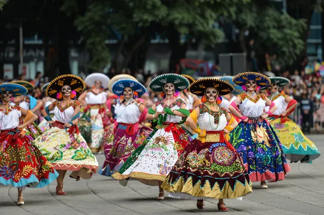 People take part in the Day of the Dead parade in Mexico City on October 27, 2018. (Photo byXinhua News Agency/Barcroft Media)