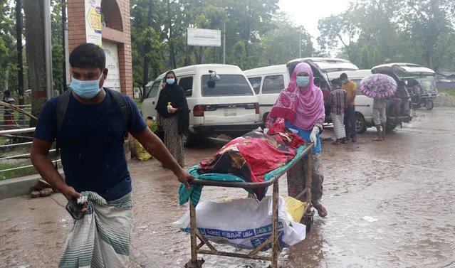 People leave for home with body of a relative at the Medical College Hospital in Rajshahi, 254 kilometers (158 miles) north of the capital, Dhaka, Bangladesh, June 15, 2021. Rajshahi has become one of the latest hotspots for the deadlier delta variant of the coronavirus. Bangladeshi authorities are increasingly becoming worried over the quick spread of coronavirus in about two dozen border districts close to India amid concern that the virus could devastate the crowded nation in coming weeks. (Photo by Kabir Tuhin/AP Photo)