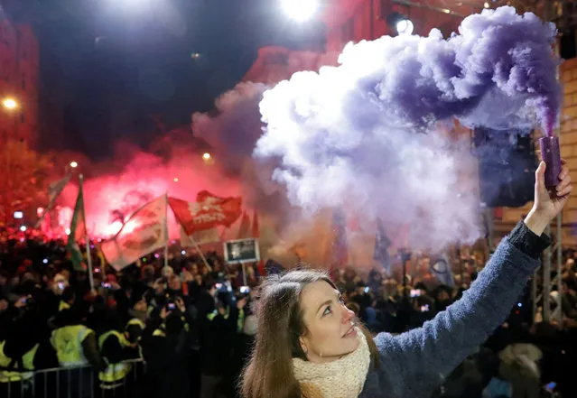 Anna Donath, Vice President of the opposition party Momentum Movement, holds a flare during a protest against a proposed new labor law, billed as the “slave law”, in Budapest, Hungary, December 16, 2018. (Photo by Bernadett Szabo/Reuters)