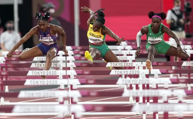 Christina Clemons of Team United States, left, competes in a semifinal heat of the Women's 100m Hurdles during the Athletics competition portion of theTokyo 2020 Olympic Games Tokyo Olympic Stadium on Sunday, August 1, 2021. (Photo by Toni L. Sandys/The Washington Post)