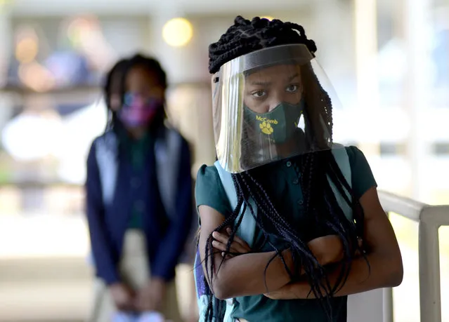 Victoria Dickens wears a mask and face shield as she waits for her class assignment at Summit Elementary School in Summit, Miss., on Thursday, August 5, 2021, the first day of the 2021-22 school year for students in the McComb School District. the school district is requiring face masks on buses and campuses this school year. (Photo by Matt Williamson/Enterprise-Journal via AP Photo)