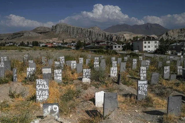 A picture taken on August 16, 2021 in Van, eastern Turkey, shows gravestones of unidentified migrants who have died crossing the Turkish-Iran border. The latest chaos in Afghanistan sparked by the recent gains of territory by the Taliban including the takeover of the capital Kabul has raised fresh alarm over an influx of migrants into Turkey through the Iranian border. Turkey, which shares a 534 kilometre (331 miles) border with Iran, has beefed up its frontier and started building a 243 kilometre wall in a bid to prevent any passage of illegal migrants.  (Photo by Ozan Kose/AFP Photo)