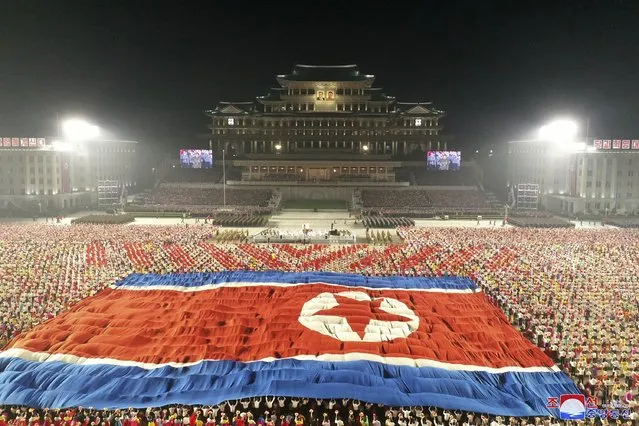 In this photo provided by the North Korean government, a huge North Korean flag is displayed during a celebration of the nation’s 73rd anniversary at Kim Il Sung Square in Pyongyang, North Korea, early Thursday, September 9, 2021. (Photo by KCNA via KNS/AFP Photo/Stringer)