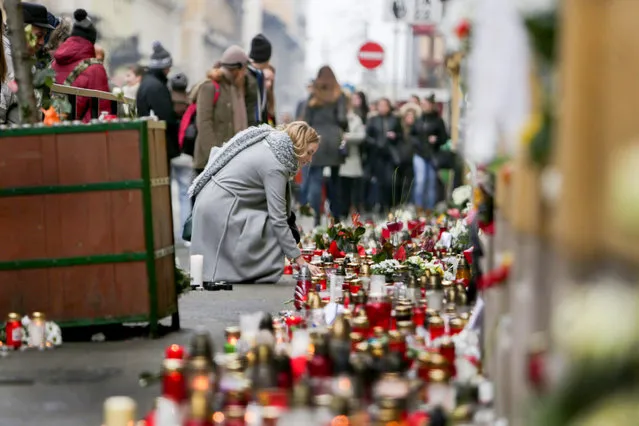 Budapest students light candles at a makeshift memorial outside Szinyei Merse Pal Secondary School to pay tribute to victims of the crash of a Hungarian bus in Italy in Budapest, Hungary, Monday, January 23, 2017. Hungary observes a day of national mourning after a bus carrying students of this secondary school from France back to Hungary crashed on a highway near Verona last Friday night killing more than a dozen people. (Photo by Szabó Gábor/Origo)