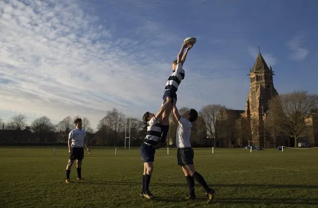 A pupil catches a ball as he takes part in rugby practice on the playing fields of Rugby School in central England, January 20, 2015. (Photo by Neil Hall/Reuters)