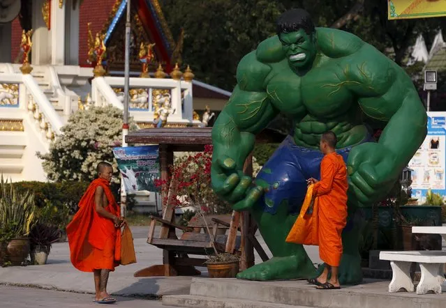 Buddhist monks walk past a statue of comic character “The Hulk” at Tamru Temple in Samut Prakan province outside Bangkok, Thailand, March 3, 2016. (Photo by Chaiwat Subprasom/Reuters)