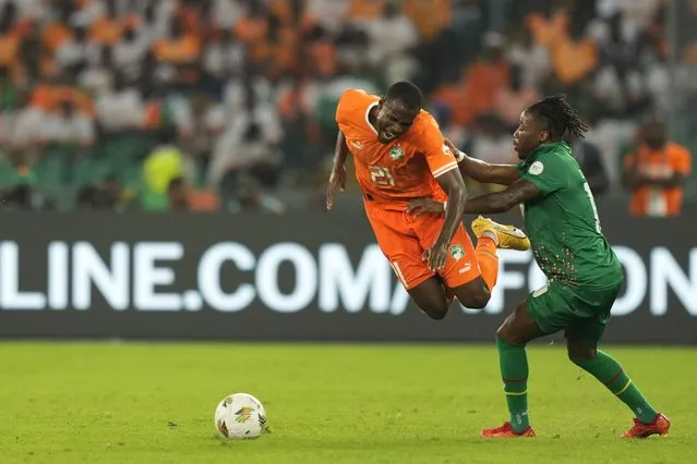 Ivory Coast's Evan Ndicka, left, is challenged by Guinea-Bissau's Carlos Mane during the African Cup of Nations Group A soccer match between Ivory Coast and Guinea-Bissau in Abidjan, Ivory Coast, Saturday, January 13, 2024. (Photo by Sunday Alamba/AP Photo)
