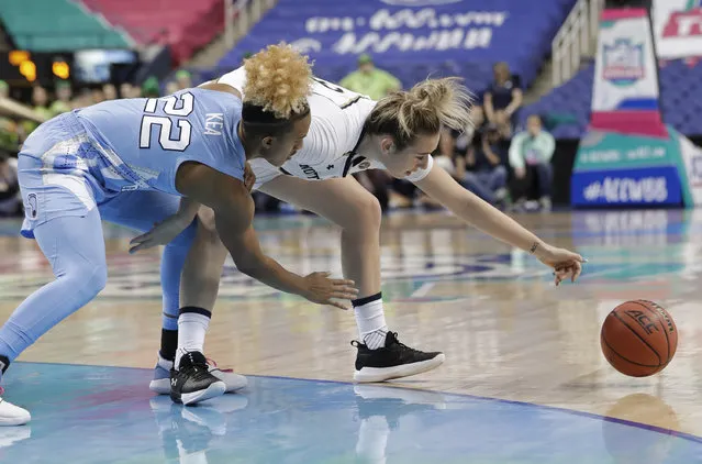 North Carolina's Paris Kea (22) and Notre Dame's Marina Mabrey (3) chase a loose ball during the first half of an Atlantic Coast Conference women's tournament NCAA college basketball game in Greensboro, N.C., Friday, March 8, 2019. (Photo by Chuck Burton/AP Photo)