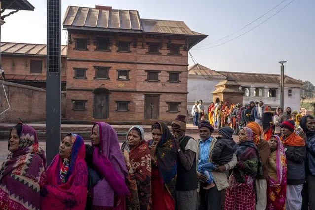 Indian pilgrims line up, forming a queue as they wait to enter Pashupatinath temple in Kathmandu, Nepal, January 9, 2024. The centuries-old  temple is one of the most important pilgrimage sites in Asia for Hindus. Nepal and India are the world’s two Hindu-majority nations and share a strong religious affinity. Every year, millions of Nepalese and Indians visit Hindu shrines in both countries to pray for success and the well-being of their loved ones. (Photo by Niranjan Shrestha/AP Photo)
