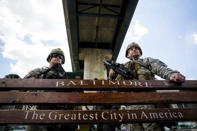 National Guard troops stand watch along E. Pratt St. in Baltimore, Maryland April 28, 2015. (Photo by Eric Thayer/Reuters)
