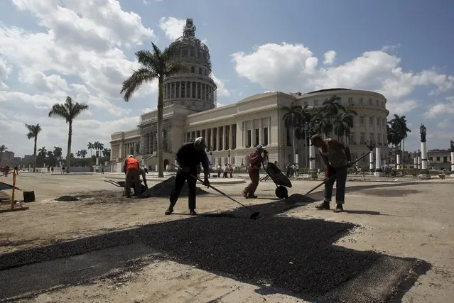 Workers repair a street near the Capitolio building in Havana, March 16, 2016. (Photo by Reuters/Stringer)