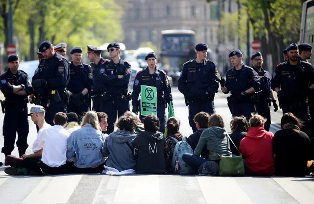 Police officers stand line as climate change activists block “Ring” road during the Extinction Rebellion protest in Vienna, Austria, April 17, 2019. (Photo by Lisi Niesner/Reuters)