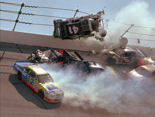In this April 28, 1996, file photo, NASCAR driver Ricky Craven (41) flips into the catchfence in turn one of the Talladega Superspeedway during the Winston Select 500, in Talladega, Ala. Also visible are Derrike Cope (12), Geoff Bodine (7), Brett Bodine (11), Jeff Gordon (24), and Jeff Purvis (44). The ever-present air of unpredictability at Talladega Superspeedway is even more pronounced than usual this weekend, with NASCAR having replaced the horsepower-sapping restrictor plates. (Photo by Ashley Fleming/AP Photo/File)