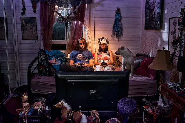 In his series of untitled photographs Nobody Claps Anymore, the Mexican-American photographer Alec Dawson portrays ordinary people in their homes in a downbeat, ultra-stylised manner. Staring into space as they watch TV or water the garden, the real-life subjects of photographer hint at vast reserves of boredom and regret. (Photo by Alec Dawson)