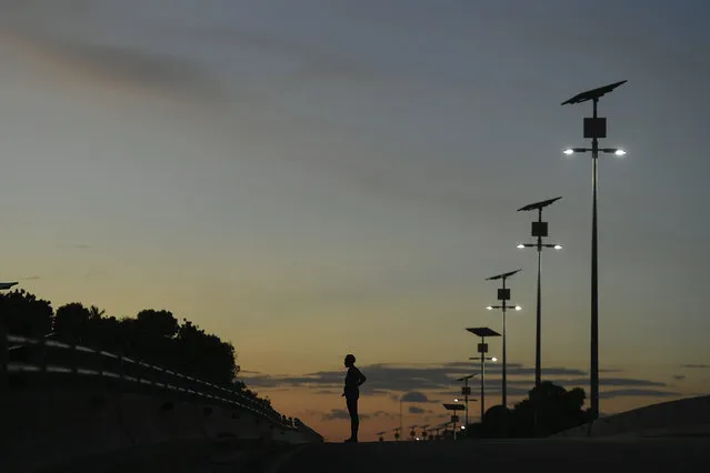 A woman stands on a bridge of a normally busy main road in Port-au-Prince, Haiti, Thursday, November 11, 2021. (Photo by Matias Delacroix/AP Photo)