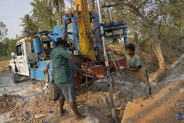 Laborers work to drill a borewell for groundwater in Bengaluru, India, Monday, March 11, 2024. Groundwater, relied on by over a third of the city's 13 million-strong population, is fast running out. (Photo by Aijaz Rahi/AP Photo)