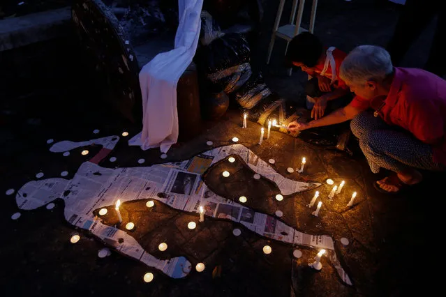 Peace advocates light candles to symbolize mourning over cases of extra-judicial killings and the halt in peace talks between the Philippine government and communist rebels, at a mini-park in Quezon City, east of Manila, Philippines 22 February 2017. Seminarians, nuns, priests and peace advocates gathered to pray for victims in extra-judicial killings, many of which are related to the government's war on illegal drugs, and to pray for the resumption of peace talks between government and rebels. In its Annual Report for 2016 to 2017, Amnesty International states that in the Philippines “The government launched a campaign to crackdown on drugs in which over 6,000 people were killed. Human rights defenders and journalists were also targeted and killed by unidentified gunmen and armed militia. The use of unnecessary and excessive force by police continued”. (Photo by Rolex dela Peña/EPA)