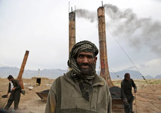 Mohammad Malook 55, poses for a photograph as he works at a brick factory on the outskirts of Kabul, Afghanistan, Monday, April 21, 2014. Men generally work for 8 hours a day, six days a week, and make about 350 Afghani ($6) per day. (Photo by Rahmat Gul/AP Photo)