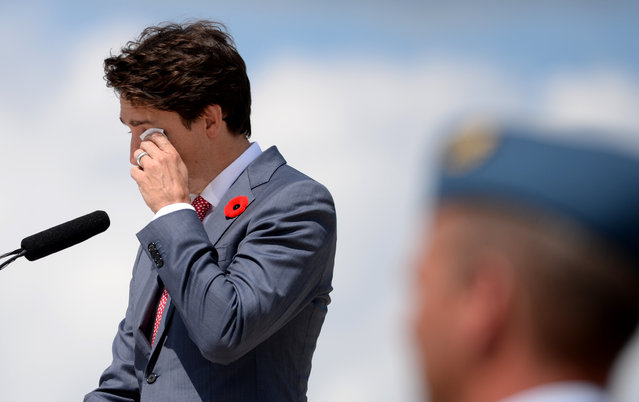 Canadian Prime Minister Justin Trudeau wipes a tear as he delivers a speech during the international ceremony on Juno Beach in Courseulles-sur-Mer, Normandy, northwestern France, on June 6, 2019, as part of D-Day commemorations marking the 75th anniversary of the World War II Allied landings in Normandy. (Photo by Guillaume Souvant/AFP Photo)