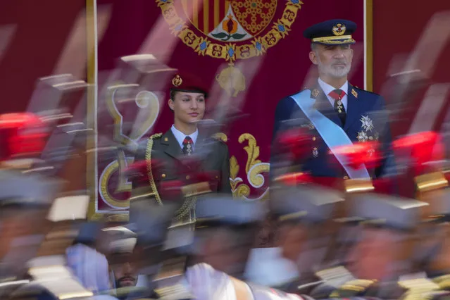 Spain's Princess Leonor, left, and King Felipe VI attend the military parade on the national holiday known as “Dia de la Hispanidad” or Hispanic Day in Madrid, Spain, Thursday, October 12, 2023. Spain commemorates Christopher Columbus' arrival in the New World and also Spain's Armed Forces Day. (Photo by Manu Fernandez/AP Photo)