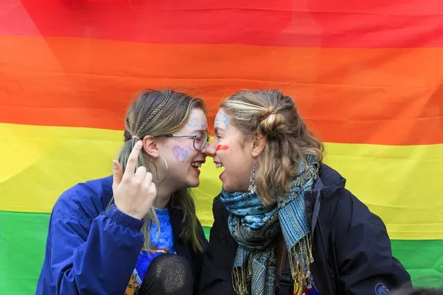 Two young women attend a rally to mark International Women's Day in Tbilisi, Georgia, Wednesday, March 8, 2017. Women around the globe are taking to the streets to mark the day. (Photo by Shakh Aivazov/AP Photo)