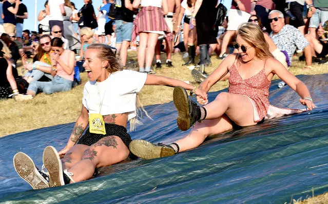 Festival goers ride a makeshift slip and slide during day two of Glastonbury Festival at Worthy Farm, Pilton on June 27, 2019 in Glastonbury, England. (Photo by Shirlaine Forrest/WireImage)