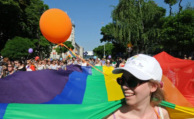 Marchers carry a multicolor flag during the annual gay pride parade in Warsaw, Poland, Saturday, June 13, 2015. Gay rights activists held their 15th yearly "Equality Parade" as Poland slowly grows more accepting of gays and lesbians, but where gay marriage, and even legal partnerships, still appear to be a far-off dream. This year's parade comes amid a right-wing political shift, a possible setback for the LGBT community. (AP Photo/Alik Keplicz)