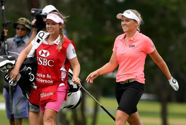 Brooke Henderson of Canada and her caddie Brittany Henderson on the 18th hole during the first round of the HSBC Women's Champions on the Tanjong course at Sentosa Golf Club on March 2, 2017 in Singapore. (Photo by Ross Kinnaird/Getty Images)