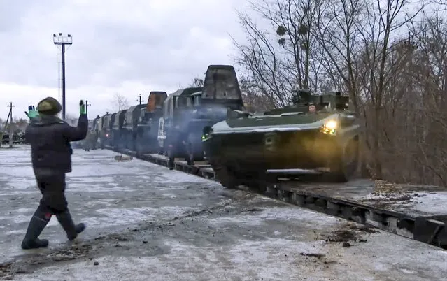 In this photo taken from video provided by the Russian Defense Ministry Press Service, A Russian armored vehicle drives off a railway platform after arrival in Belarus, Wednesday, January 19, 2022. In a move that further beefs up forces near Ukraine, Russia has sent an unspecified number of troops from the country's far east to its ally Belarus, which shares a border with Ukraine, for major war games next month. (Photo by Russian Defense Ministry Press Service via AP Photo)