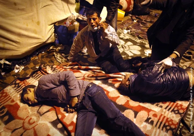 Protestors suffering from the effects of tear gas fired by police lie in a make shift medical centre in Tahrir Square