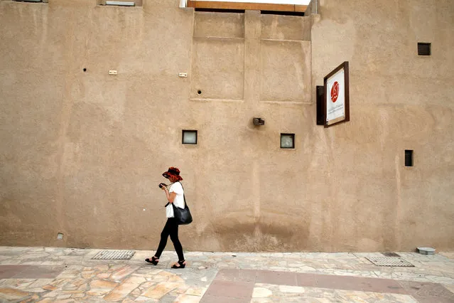 A tourist walks past an old building at Al Bastakiya, a historic district in Dubai, UAE March 7, 2016. (Photo by Ahmed Jadallah/Reuters)