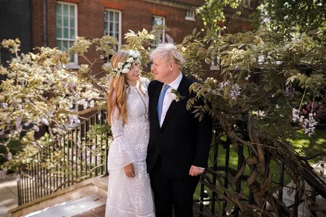 A handout picture released by 10 Downing Street on May 30, 2021 shows Britain's Prime Minister Boris Johnson and his wife Carrie Johnson in the garden of 10 Downing Street, London after their wedding on Saturday, May 29, 2021. British Prime Minister Boris Johnson and his fiancee Carrie Symonds married over the weekend, his office confirmed Sunday, May 30, in what media reports have described as a “secret ceremony”. (Photo by Rebecca Fulton/10 Downing Street/AFP Photo)