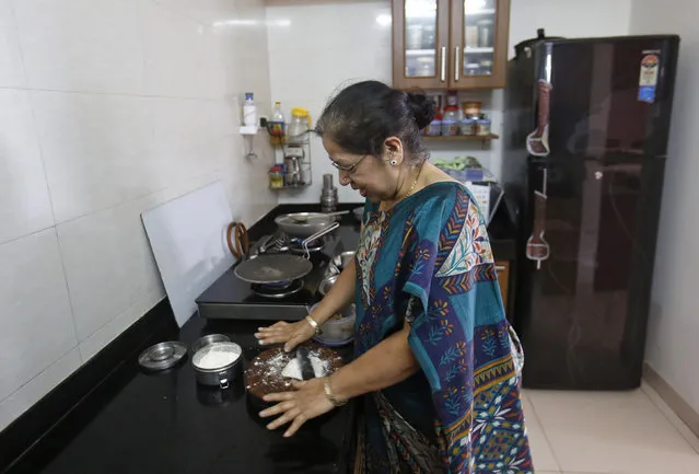 Rekha Chitre, 63, cooks in the kitchen of her flat at the Athashri retirement village in Baner, on the outskirts of Pune, June 18, 2013. (Photo by Danish Siddiqui/Reuters)