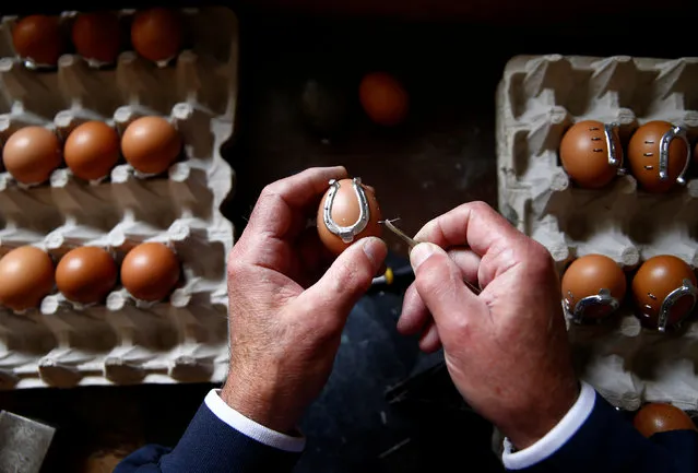 Stjepan Biletic calks a decorated egg with small horseshoes in his workshop in Kresevo, Bosnia and Herzegovina, April 13, 2017. (Photo by Dado Ruvic/Reuters)
