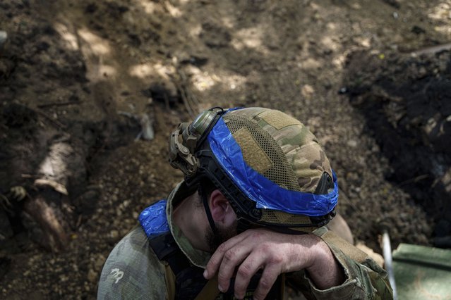 A Ukrainian national guard serviceman of Khartia brigade prepares to reload his D-20 cannon while firing towards Russian positions on the front line near Kharkiv, Ukraine, Monday, June 10, 2024. (Photo by Evgeniy Maloletka/AP Photo)