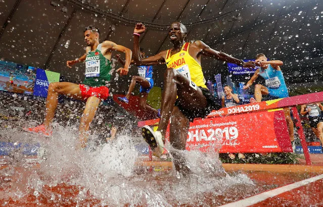 Uganda's Benjamin Kiplagat, left, and Morocco's Mohamed Tindouft, right, compete in the Men's 3000m steeplechase heats at the 2019 IAAF Athletics World Championships in Doha, Qatar on October 1, 2019. (Photo by Kai Pfaffenbach/Reuters)