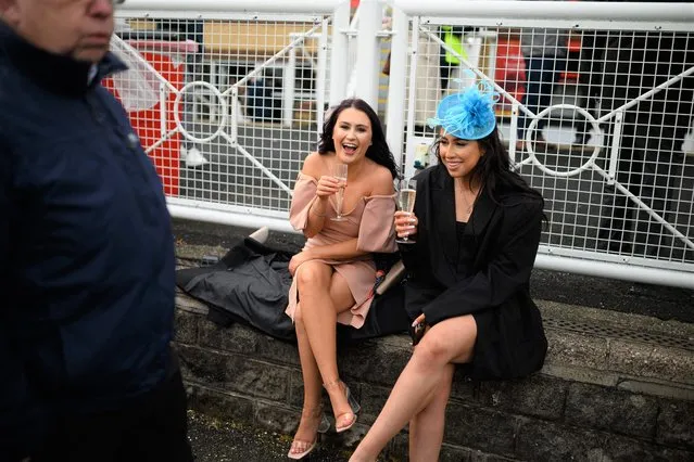 Racegoers attend the opening day of the Grand National Festival horse race meeting at Aintree Racecourse in Liverpool, north west England on April 7, 2022. (Photo by Oli Scarff/AFP Photo)