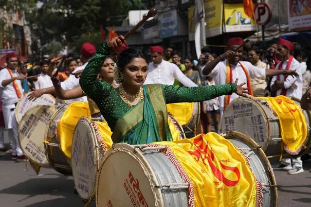 Women dressed in traditional attire dance during a procession to mark Gudi Padwa, or the Marathi new year, in Mumbai, India, Saturday, April 2, 2022. (Photo by Rajanish Kakade/AP Photo)